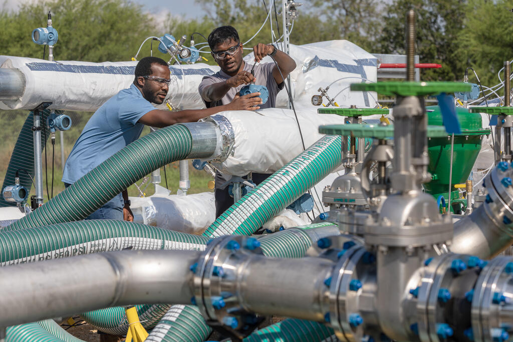 Two staff working at SwRI Large-Scale Heat Exchange Test Facility