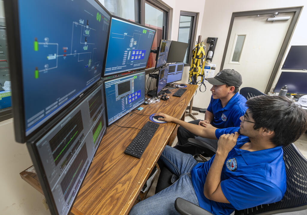 Operators at a computer using the HMI interface