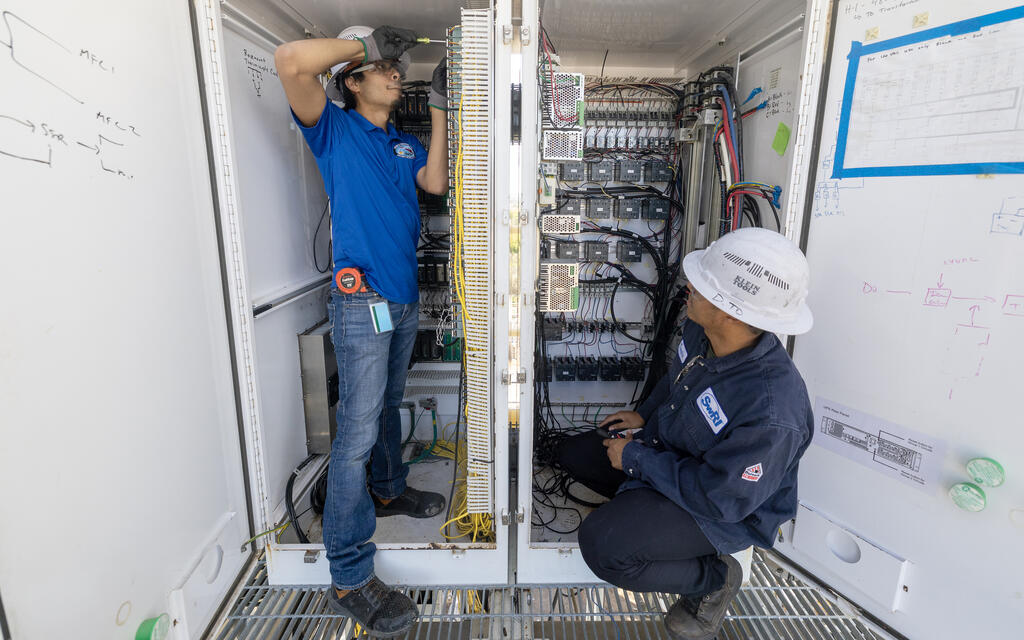 Two technicians working on hardware
