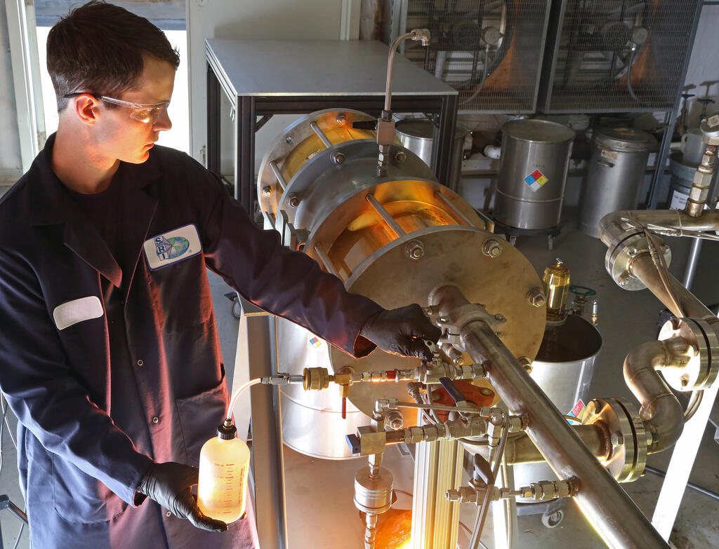 SwRI staff member working with aviation fuel filtration system