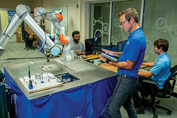 SwRI staff working in engineering lab developing robotic solutions