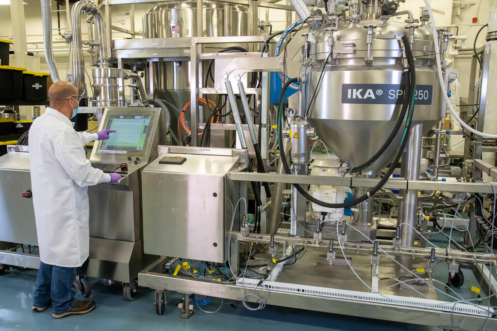 SwRI staff using spinning disc pilot production unit