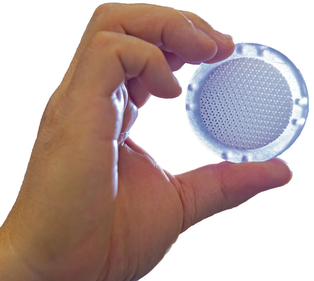 Hand holding single-use 3D-printed bioreactor