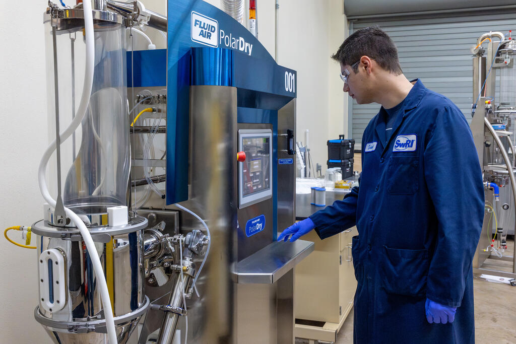 SwRI staff using the electrostatic spray dryer in SwRI lab