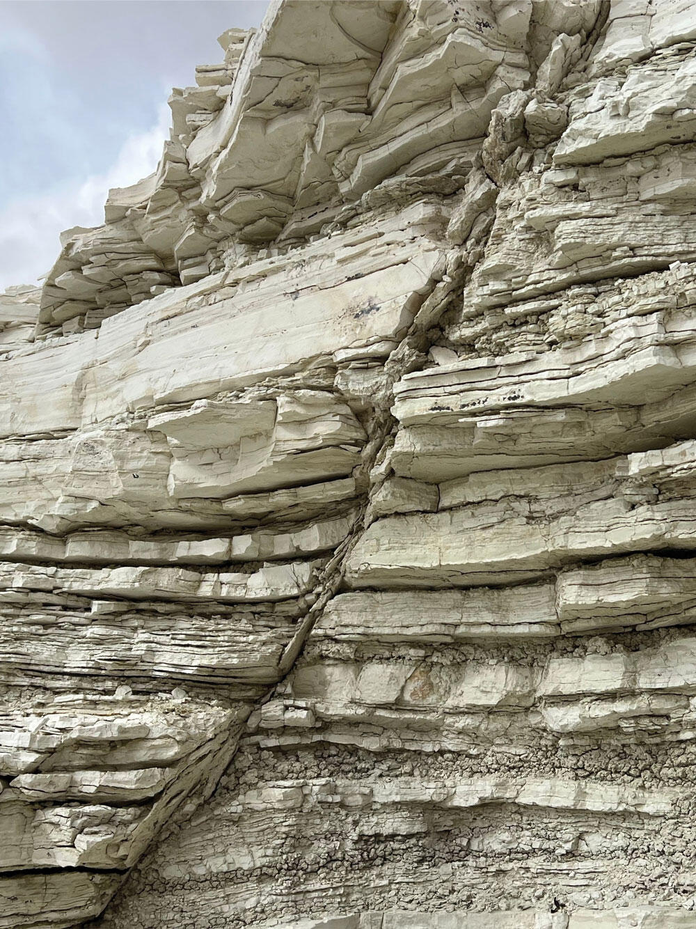 Outdoor layered volcanic ash deposits on a sunny day