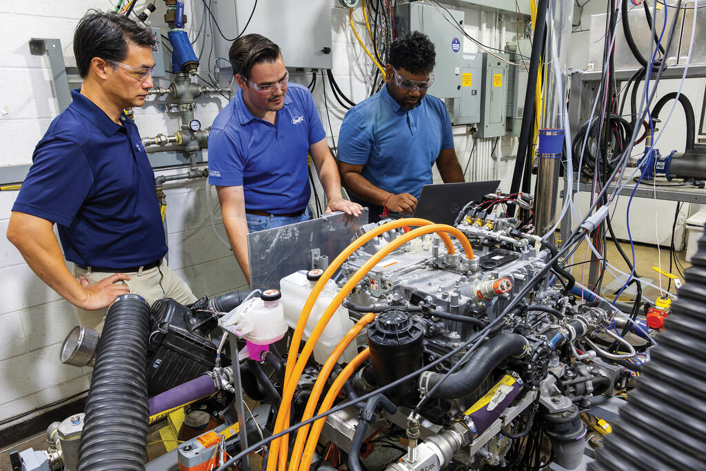 Three SwRI staff members in SwRI lab extracting a fuel cell system
