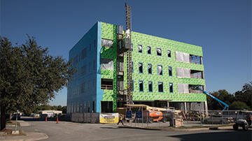 construction photo of Building 264 with Yeti sculpture in exterior elevator
