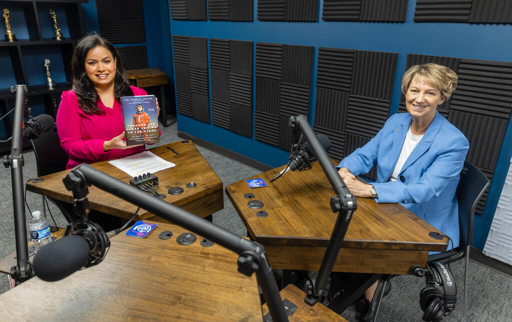 Lisa Pena holding a copy of , “Through the Glass Ceiling to the Stars,”, on left, and Col. Eileen Collins, on right, in SwRI's podcast booth
