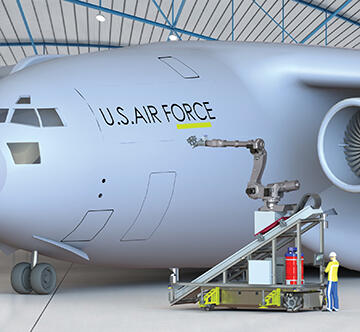 Robotic arm sanding military aircraft