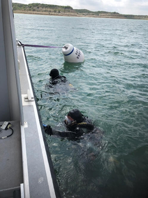 SCUBA divers preparing to explore Goodenough Spring in the Amistad International Reservoir
