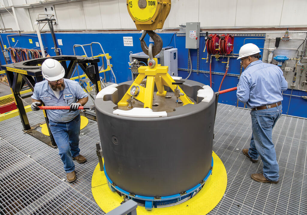 Two SwRI staff turning SwRI's new 30-inch pressure vessel