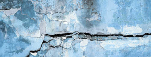 Peeling plastered wall with cracks