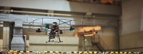 drone hovering over ventilation shaft