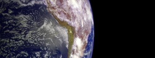 Planet Earth and moon against an empty black sky