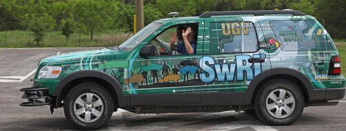 Passengers ride along in an SwRI automated vehicle as it traverses a test track