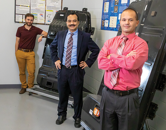 Dr. Terry Alger, Dr. Bapi Surampudi, and Ian Smith posing in a lab.