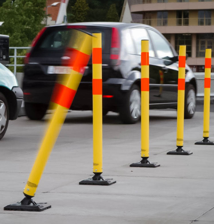 black SUV driving alongside traffic control markers