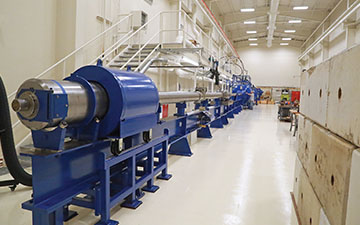 metal cylinder on a blue frame in a long warehouse