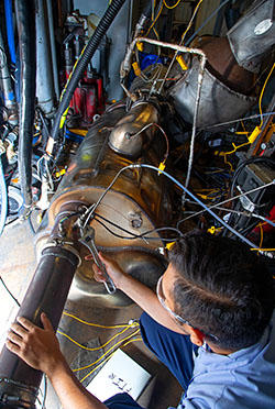 Technician making adjustments on the ultra-low NOx test cell