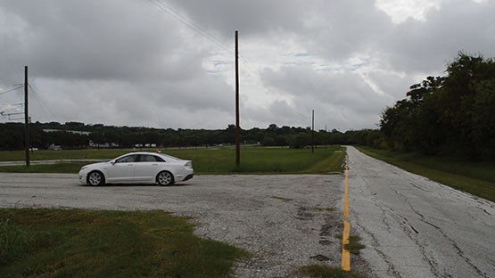 Car on a roadway that is turned, facing towards the side of the road